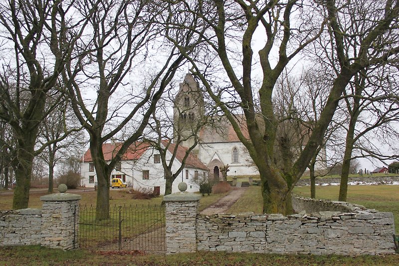Utsikt över kyrkan och en prästgård.